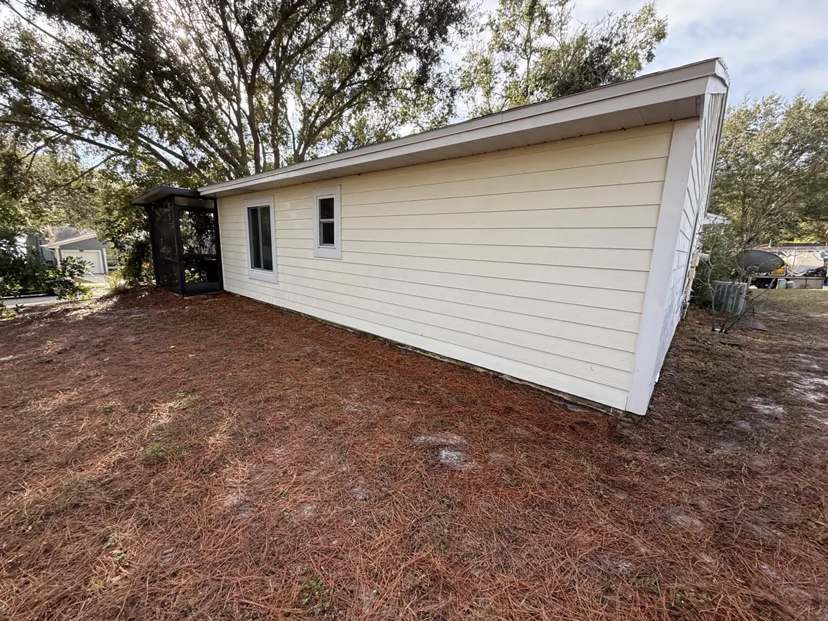 Same Tampa Bay home with clean bright-white siding after JAB soft wash